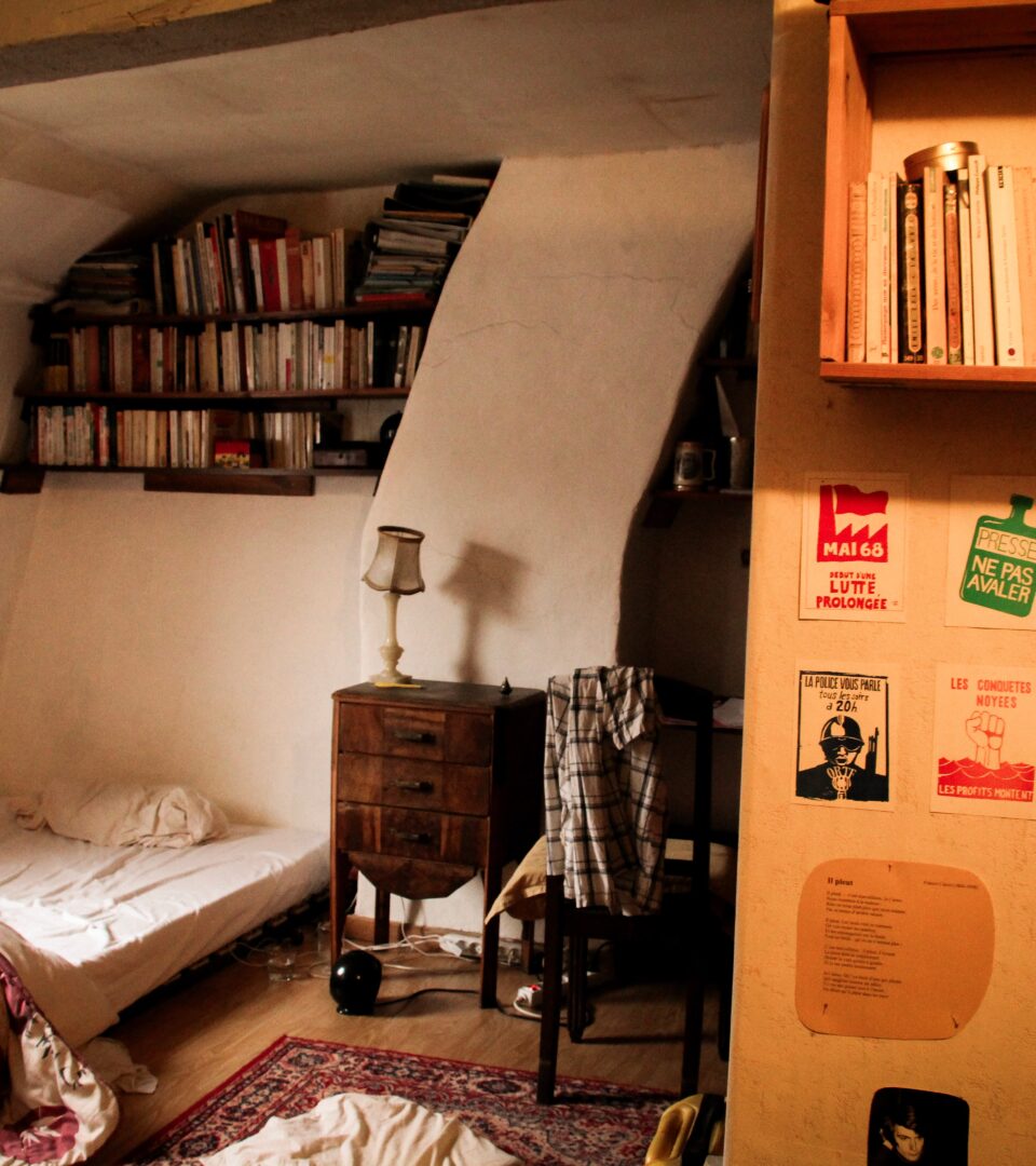À l’étage de la maison de Marc Dubrul, une chambre nichée sous une poutre ancienne, entourée de sa collection de livres. 